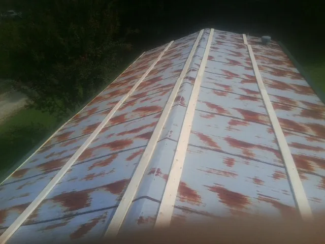 Rusted metal roof panels with new wood purlins before replacement — Storm Damage Roof Repair in Eutawville by Roofing Brothers